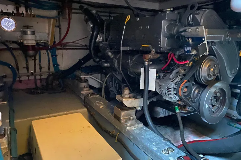 Slide: The Image of Engine room of 1988 Hatteras 40 Double Cabin yacht, showcasing mechanical components. - 70