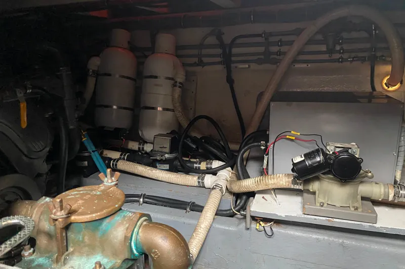 Slide: The Image of Engine room of 1988 Hatteras 40 Double Cabin with visible pipes and machinery. - 71