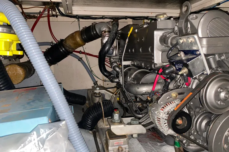 Slide: The Image of Engine room of a 1988 Hatteras 40 Double Cabin yacht, showcasing mechanical components. - 72