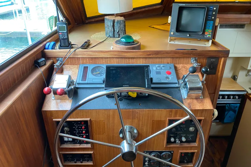 Slide: The Image of 1988 Hatteras 40 Double Cabin helm with navigation equipment and steering wheel. - 8