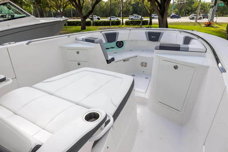 Slide: The Image of 2024 Robalo R360 Center Console boat interior with white seating and storage compartments. - 10