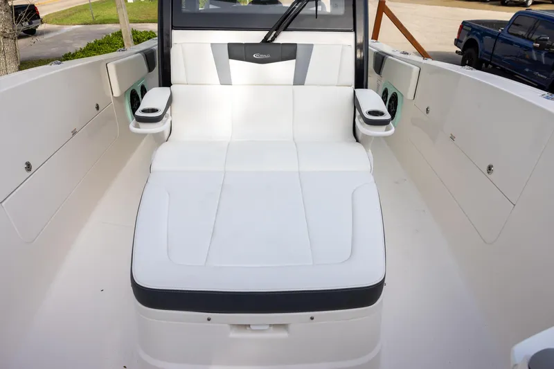 Slide: The Image of 2024 Robalo R360 Center Console boat interior with white seating and cup holders. - 11