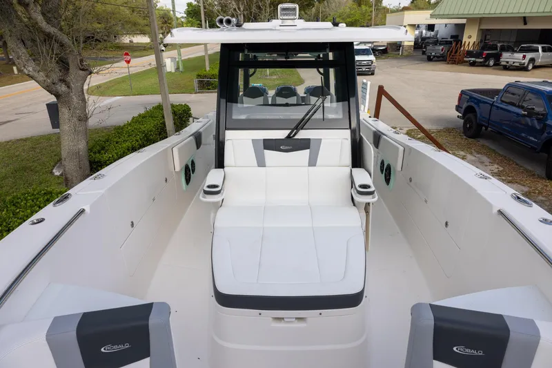 Slide: The Image of 2024 Robalo R360 Center Console boat interior with seating and console view. - 14