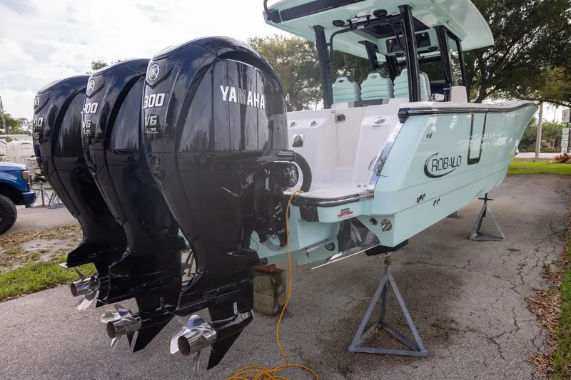 Slide: The Image of 2024 Robalo R360 Center Console with triple Yamaha 300 engines on display. - 3