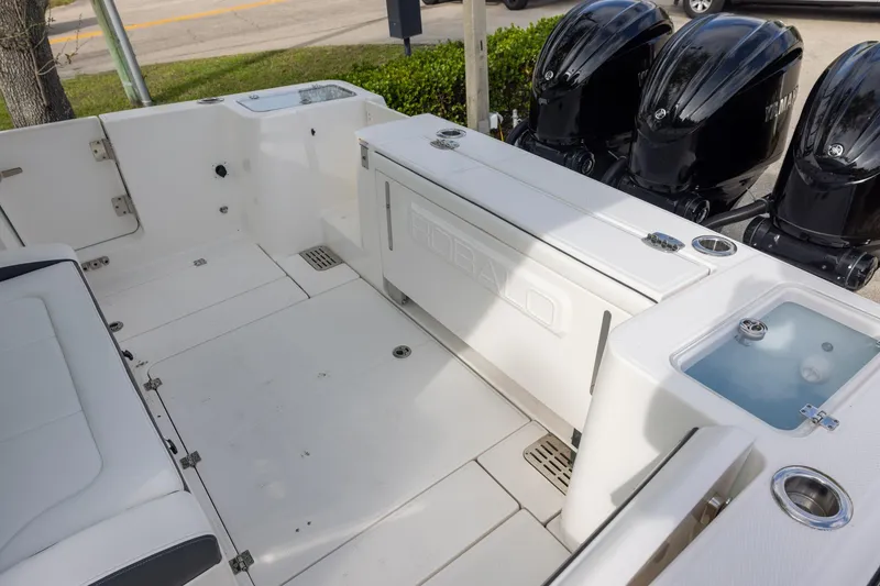 Slide: The Image of 2024 Robalo R360 Center Console boat interior with triple outboard engines. - 4