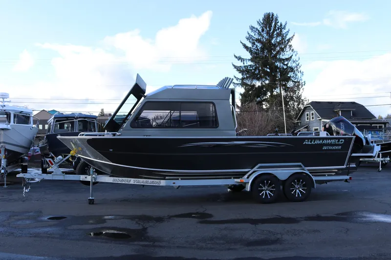 The Image of 2026 Alumaweld Intruder Hard Top 24 boat on trailer, parked outdoors. - 0