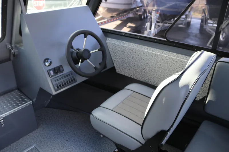 Slide: The Image of 2026 Alumaweld Intruder Hard Top 24 interior with steering wheel and captain's chair. - 13