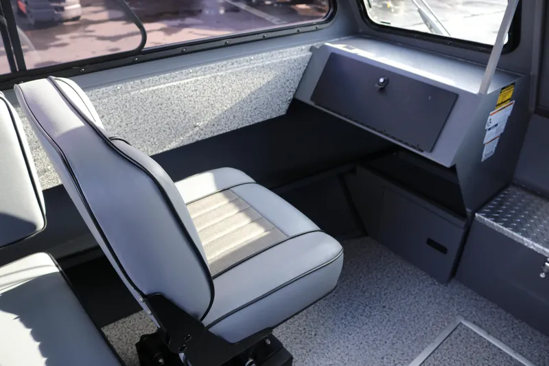 Slide: The Image of 2026 Alumaweld Intruder Hard Top 24 interior with gray seating and storage compartments. - 14
