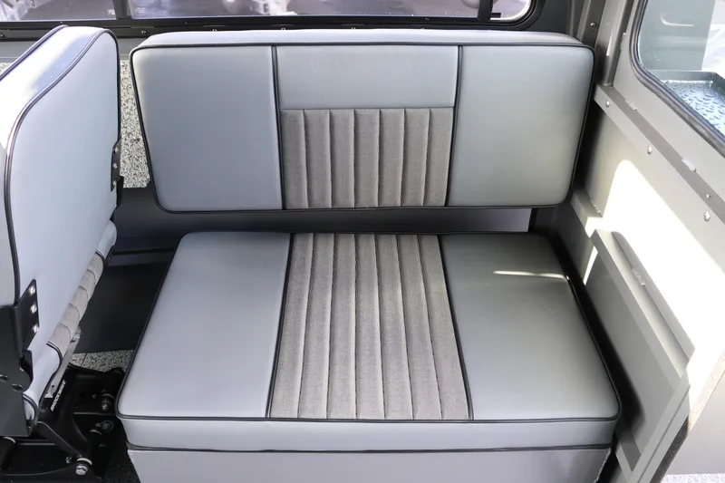 Slide: The Image of 2026 Alumaweld Intruder Hard Top 24 interior seating with gray upholstery and modern design. - 17