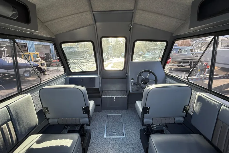 Slide: The Image of Interior of 2026 Alumaweld Intruder Hard Top 24 boat with seating and steering wheel. - 32