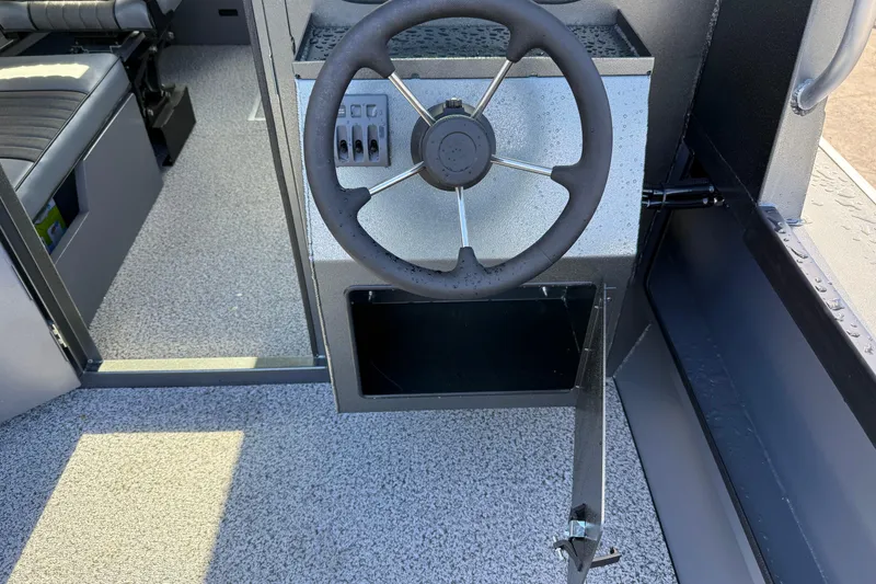 Slide: The Image of Steering console of 2026 Alumaweld Intruder Hard Top 24 boat, featuring modern controls. - 35