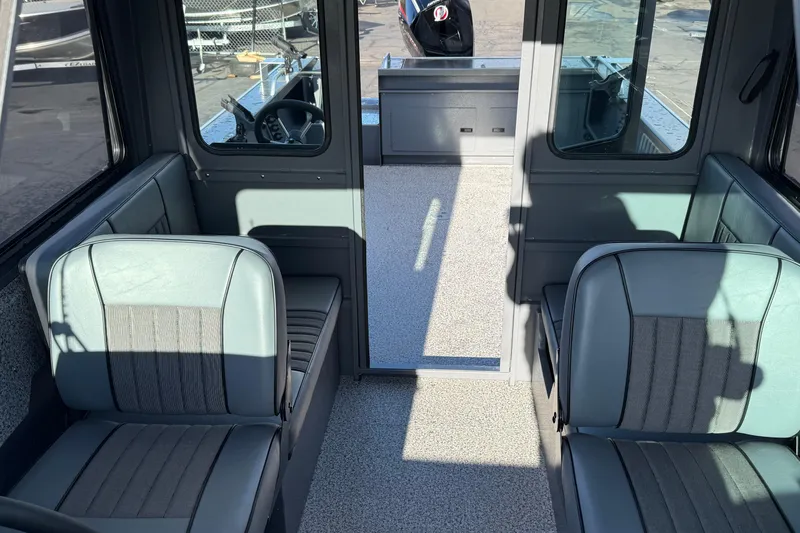 Slide: The Image of Interior of 2026 Alumaweld Intruder Hard Top 24 boat, featuring seating and helm area. - 36
