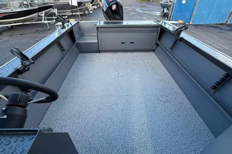 Slide: The Image of 2026 Alumaweld Intruder Hard Top 24 boat interior with spacious deck and steering wheel. - 40