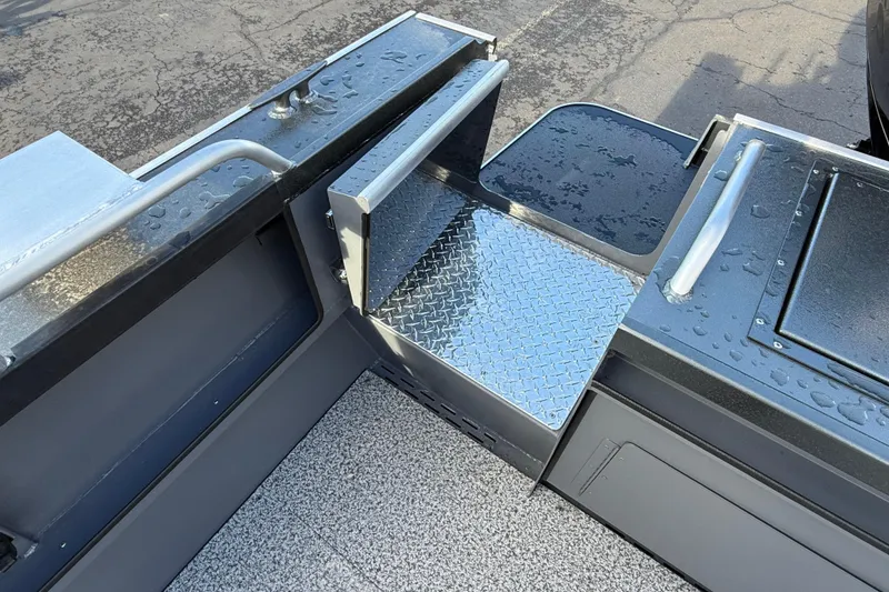 Slide: The Image of 2026 Alumaweld Intruder Hard Top 24 boat deck with diamond plate flooring and handrails. - 42