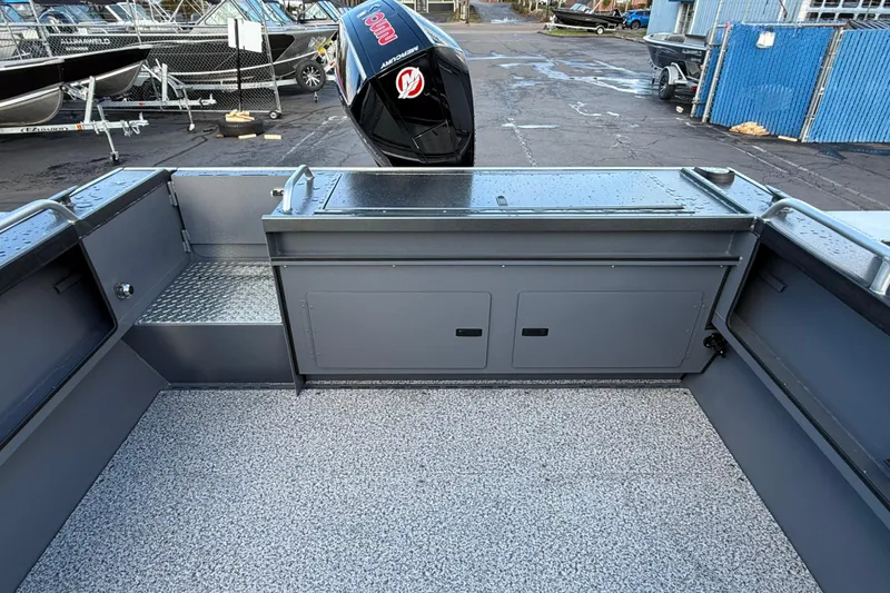 Slide: The Image of 2026 Alumaweld Intruder Hard Top 24 boat interior with storage compartments and non-slip flooring. - 44
