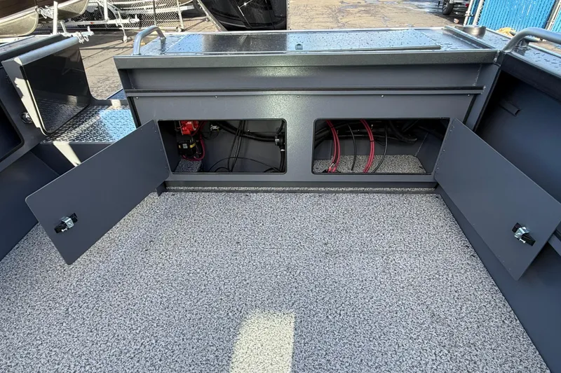Slide: The Image of 2026 Alumaweld Intruder Hard Top 24 boat interior with open storage compartments. - 48