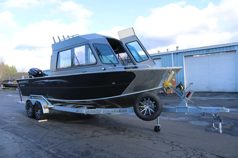 Slide: The Image of 2026 Alumaweld Intruder Hard Top 24 boat on Rogue trailer, parked outdoors. - 5