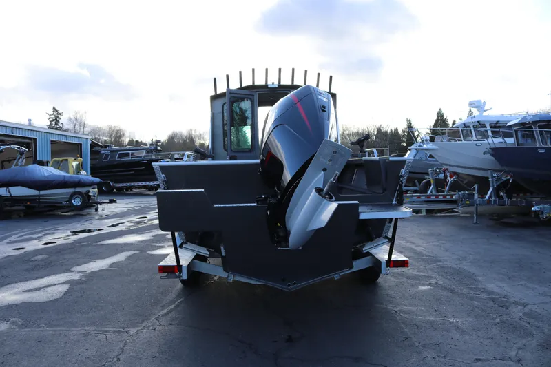 Slide: The Image of 2026 Alumaweld Intruder Hard Top 24 boat with outboard motor in a marina. - 50