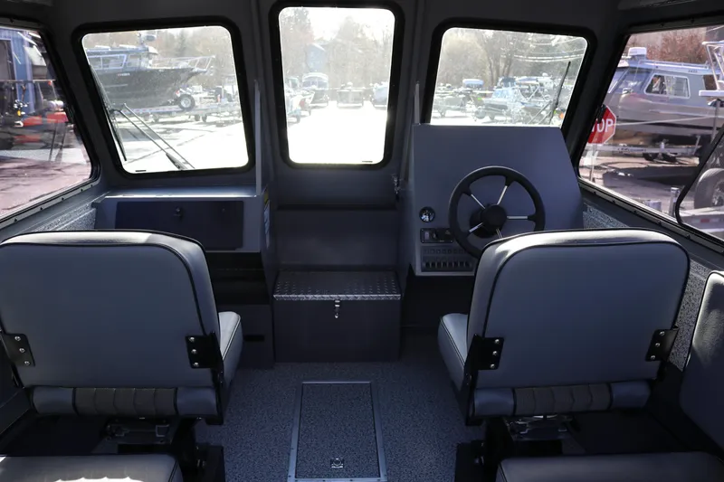 Slide: The Image of Interior of 2026 Alumaweld Intruder Hard Top 24 boat with dual seating and steering wheel. - 7