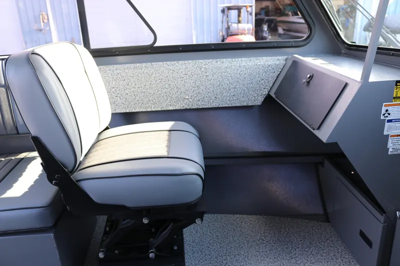Slide: The Image of Interior of 2026 Alumaweld Intruder Hard Top 24, featuring a comfortable seat and storage area. - 9