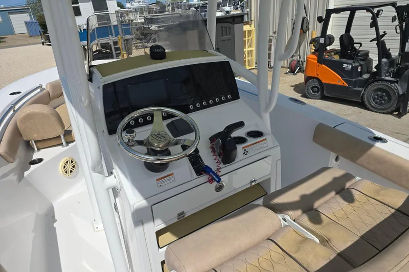 Slide: The Image of 2020 Sportsman Heritage 211 Center Console boat interior with steering wheel and controls. - 11