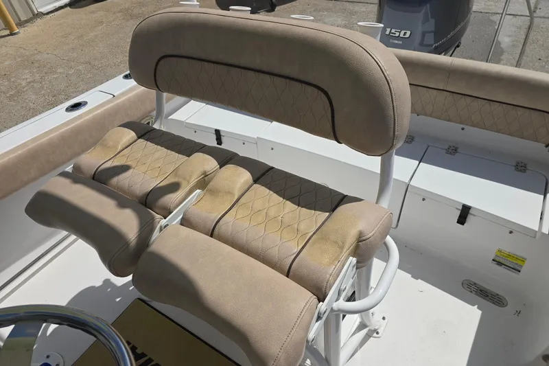 Slide: The Image of 2020 Sportsman Heritage 211 Center Console boat with tan cushioned seating and Yamaha 150 engine. - 12