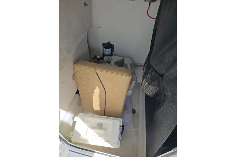 Slide: The Image of Interior storage of 2020 Sportsman Heritage 211 Center Console boat with seat cushion and equipment. - 15