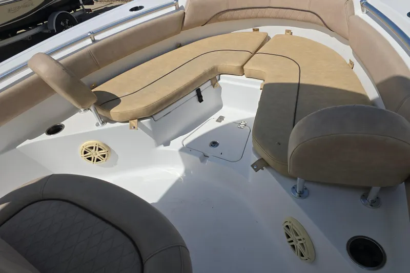 Slide: The Image of 2020 Sportsman Heritage 211 Center Console boat interior with beige cushioned seating. - 16