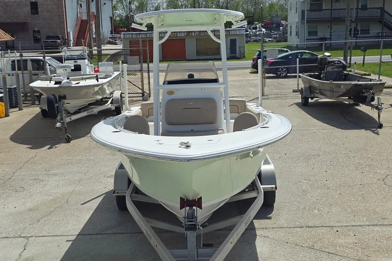 Slide: The Image of 2020 Sportsman Heritage 211 Center Console boat on trailer in a parking lot. - 2