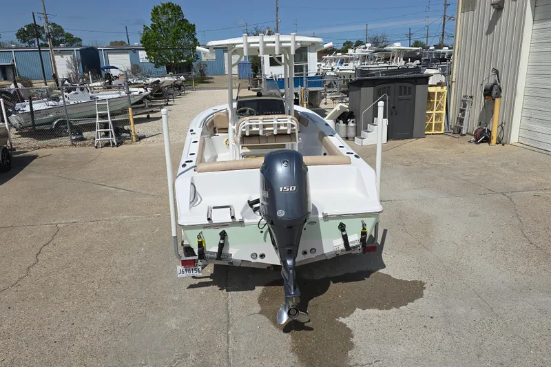 Slide: The Image of 2020 Sportsman Heritage 211 Center Console boat with Yamaha 150 engine at a marina. - 5