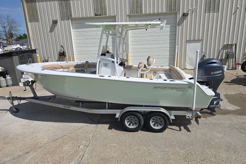 Slide: The Image of 2020 Sportsman Heritage 211 Center Console boat on trailer, parked outdoors. - 7