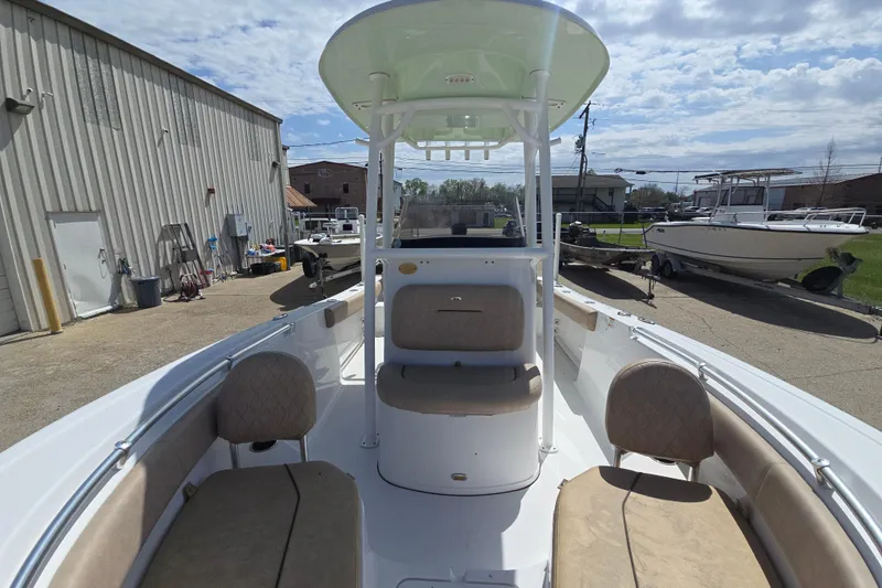 Slide: The Image of 2020 Sportsman Heritage 211 Center Console boat with beige seating, docked outdoors. - 9