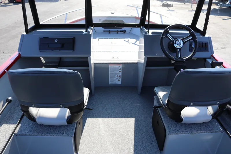 Slide: The Image of Interior of 2026 Smoker Caft Pro Tracer 162 boat with steering wheel and seats. - 17