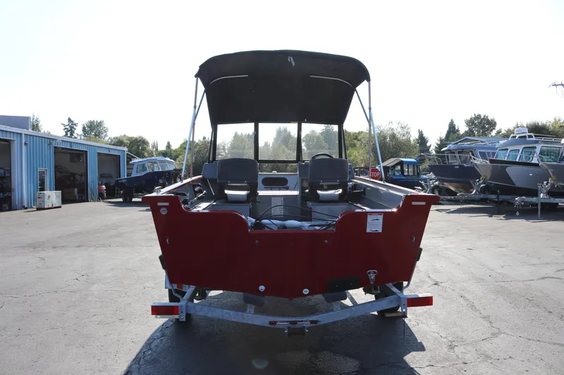 Slide: The Image of Red Smoker Caft Pro Tracer 162 boat, 2026 model, parked outdoors on a trailer. - 19