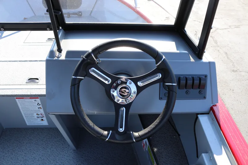 Slide: The Image of Steering wheel of 2026 Smoker Caft Pro Tracer 162 boat, featuring control panel and switches. - 6