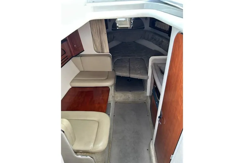 Slide: The Image of 2006 Sea Ray Sundancer 280 cabin interior with seating and sleeping area. - 11