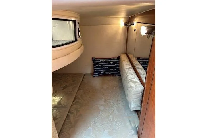 Slide: The Image of Interior cabin of 2006 Sea Ray Sundancer 280 with cozy bedding and ambient lighting. - 13