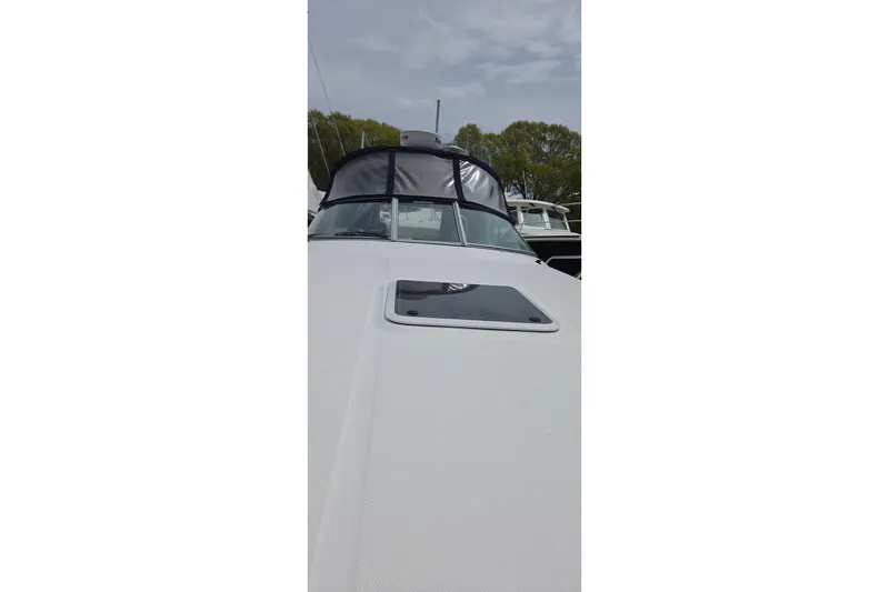 Slide: The Image of 2006 Sea Ray Sundancer 280 boat, front view with windshield and hatch, docked outdoors. - 14