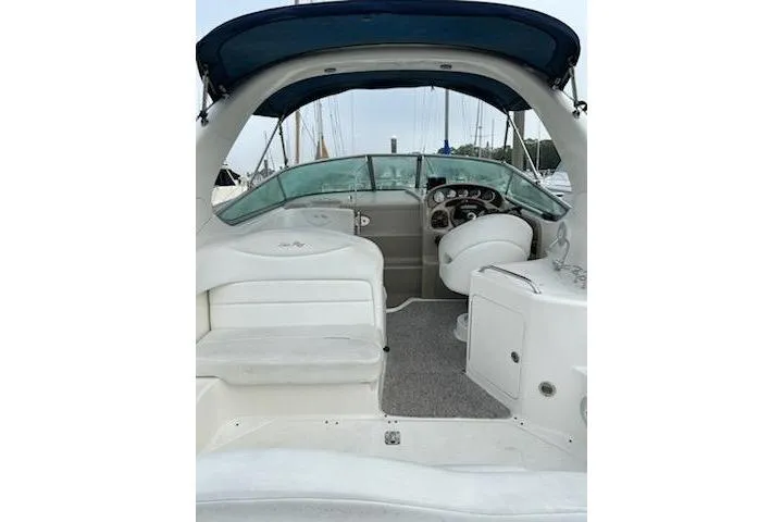 Slide: The Image of Interior of 2006 Sea Ray Sundancer 280, featuring cozy cabin with bed and kitchenette. - 17