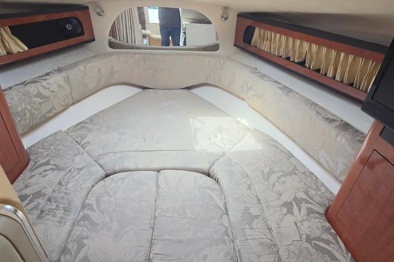 Slide: The Image of Interior cabin of 2006 Sea Ray Sundancer 280 with floral upholstery and wood accents. - 18