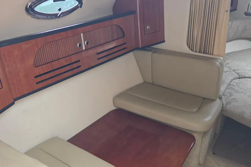 Slide: The Image of Interior of 2006 Sea Ray Sundancer 280 with wood cabinetry and beige seating. - 19