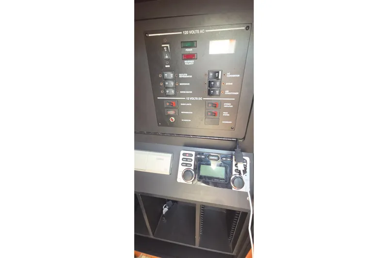 Slide: The Image of Control panel of a 2006 Sea Ray Sundancer 280 boat, featuring various switches and displays. - 26