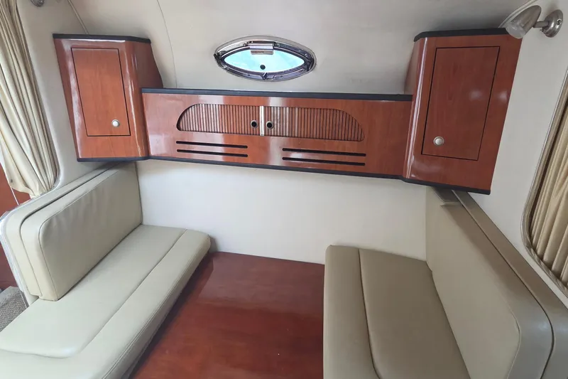 Slide: The Image of Interior of 2006 Sea Ray Sundancer 280 with wooden cabinets and beige seating. - 27