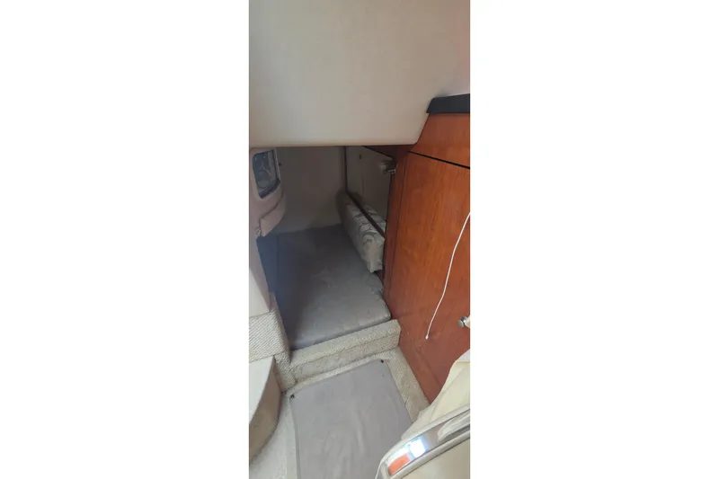 Slide: The Image of Interior cabin of 2006 Sea Ray Sundancer 280 with wood paneling and carpeted flooring. - 30
