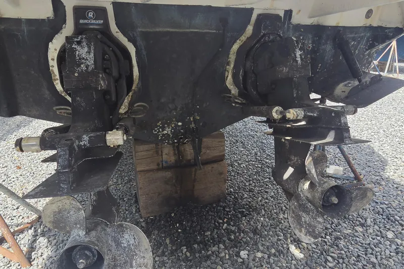 Slide: The Image of 2006 Sea Ray Sundancer 280 stern drive propellers on gravel surface. - 39