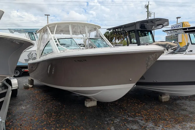 The Image of 2014 Sailfish 275 DC boat displayed outdoors on a cloudy day. - 1