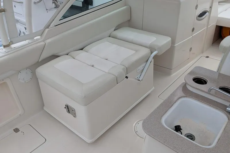 Slide: The Image of 2014 Sailfish 275 DC boat interior with white seating and built-in sink. - 13