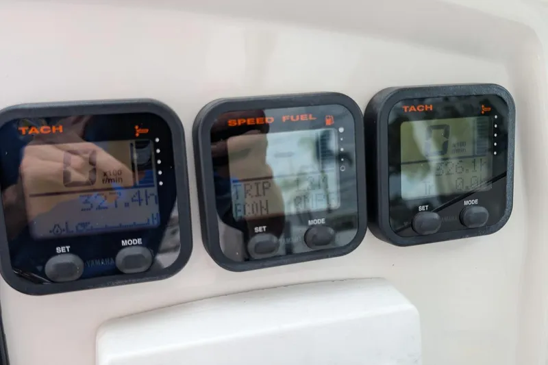 Slide: The Image of Digital gauges on a 2014 Sailfish 275 DC boat dashboard displaying tachometer and fuel information. - 16