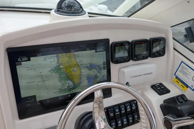 Slide: The Image of 2014 Sailfish 275 DC dashboard with navigation system and controls. - 17