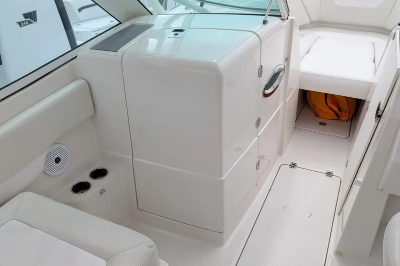 Slide: The Image of Interior of a 2014 Sailfish 275 DC boat, featuring seating and storage compartments. - 18